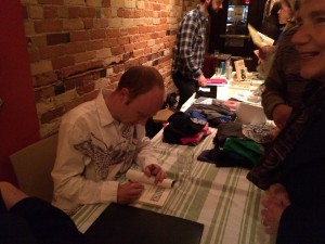 And of course Alec signed copies for his fans. Photo by Miles Dempster.